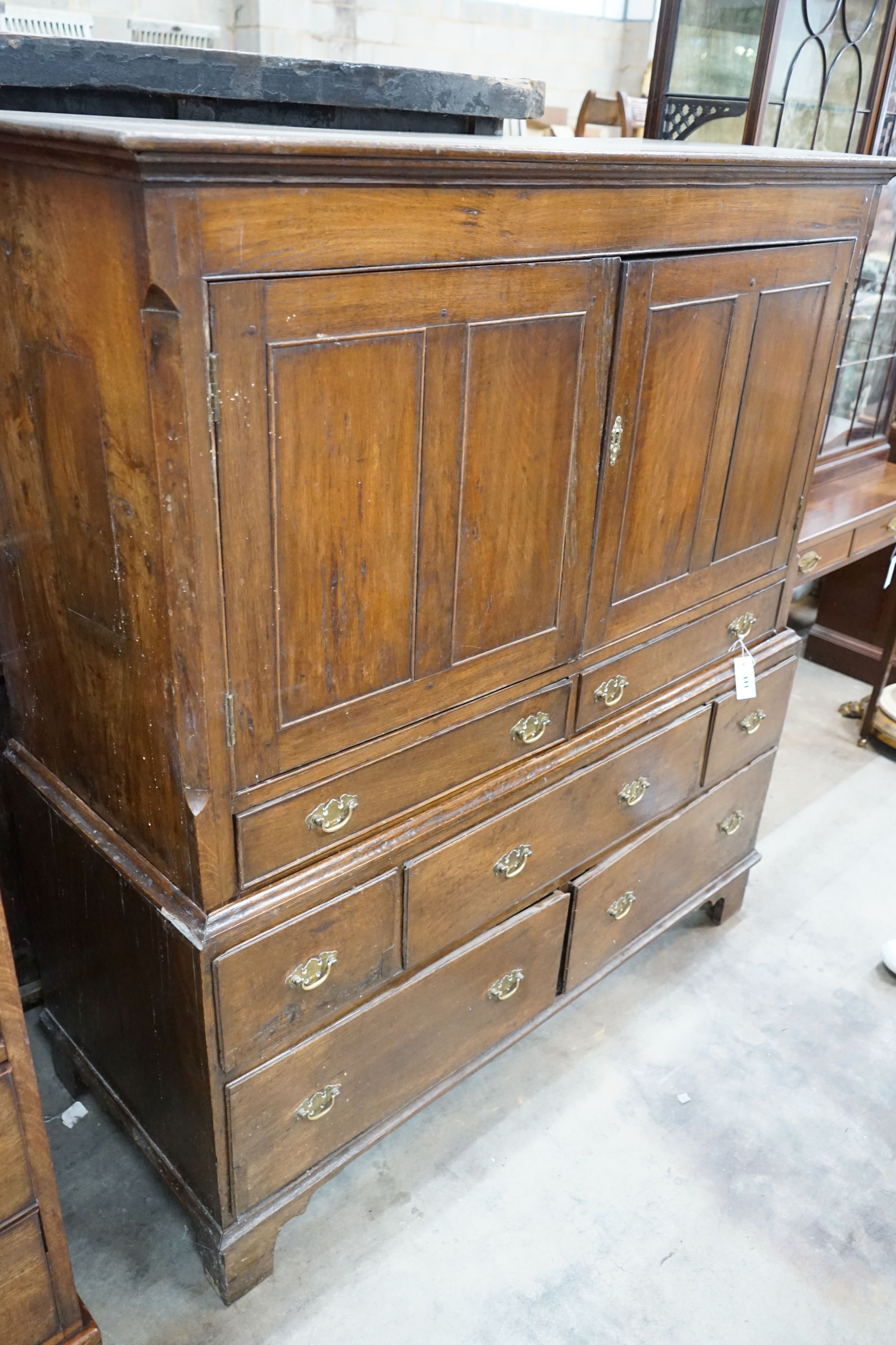 An 18th century oak two section press cupboard, width 127cm, depth 51cm, height 143cm